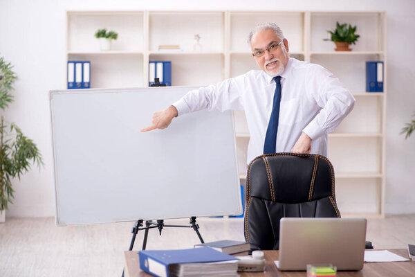 Old businessman employee working at workplace