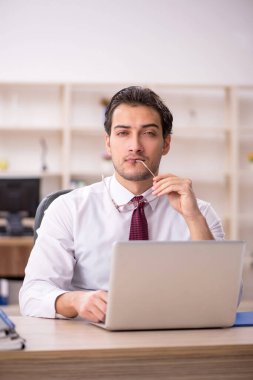 Genç işadamı ve işyerinde çok fazla iş var.