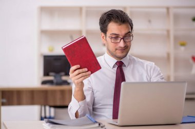 Genç işadamı ve işyerinde çok fazla iş var.