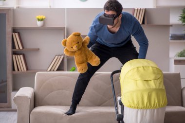 Young contractor looking after baby at home