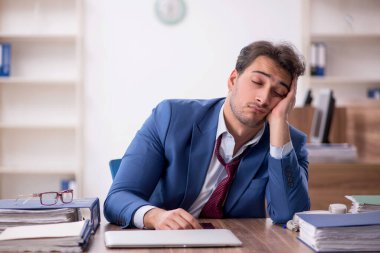 Genç işadamı işyerinde aşırı çalışmaktan memnun değil.