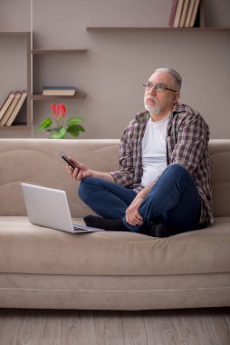 Old man sitting at home during pandemic