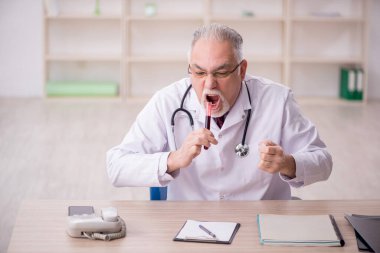 Old doctor hematologist working at the hospital