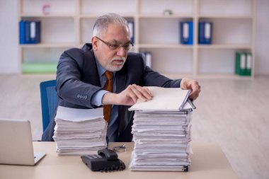 Old male employee and too much work at workplace