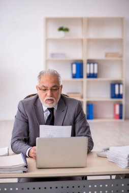 Ofiste çalışan eski bir işadamı.