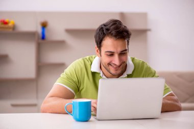 Genç erkek serbest çalışan salgın sırasında evden çalışıyor.
