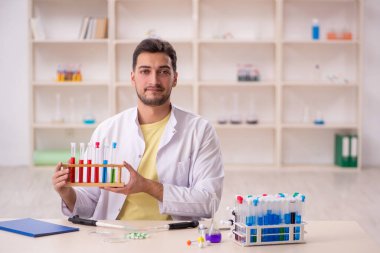 Young chemist sitting at the lab