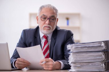 Ofisteki aşırı işten memnun olmayan eski bir işadamı.