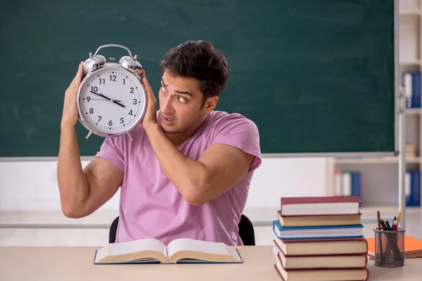 Young student preparing for exams in time management concept