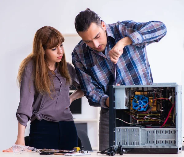 The two repairmen repairing desktop computer