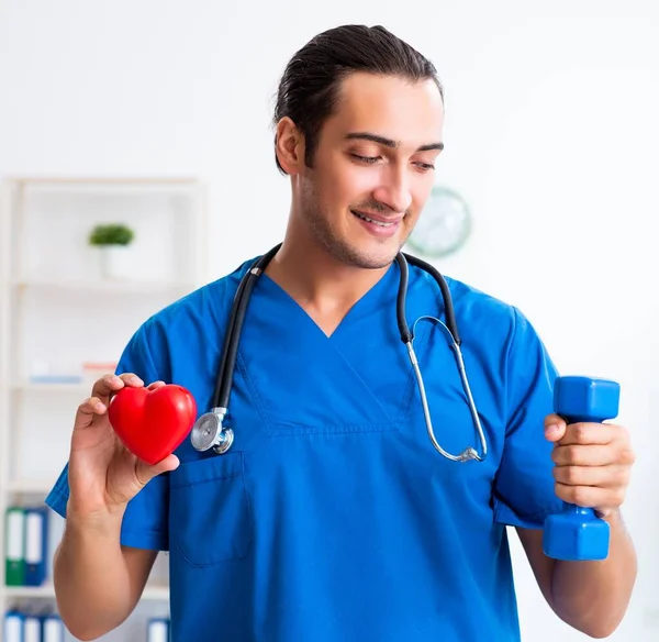The young male doctor in sport and dieting concept