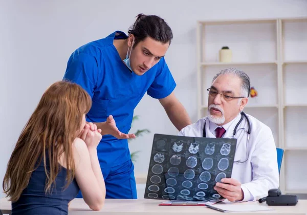 Two Doctors Examining Young Woman — Stock Photo, Image