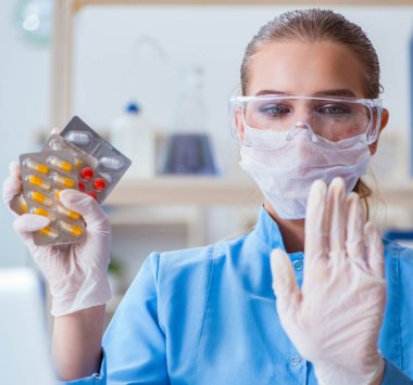 Laboratuvarda bir deney yürüten kadın bilim adamı.