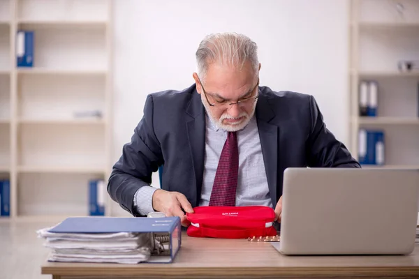 Old businessman employee feeling bad in the office