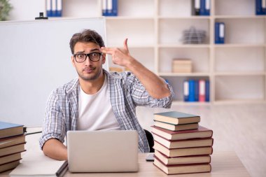 Sınıfta sınava hazırlanan genç bir öğrenci.