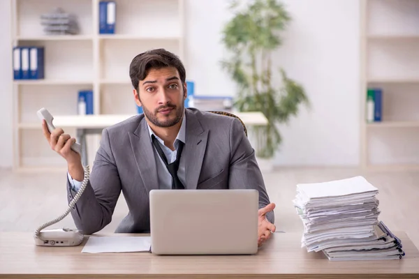 stock image Young businessman employee and too much work in the office