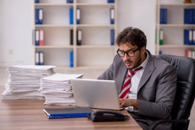 Genç işadamı ofisteki aşırı işten memnun değil.