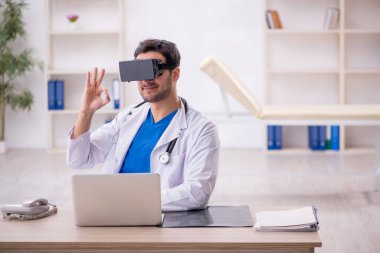 Young doctor enjoying virtual glasses at the hospital