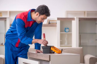 Evde çalışan genç bir marangoz.