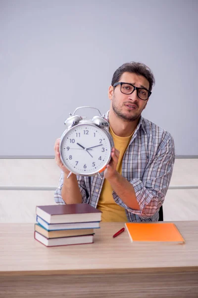 Young student in time management concept