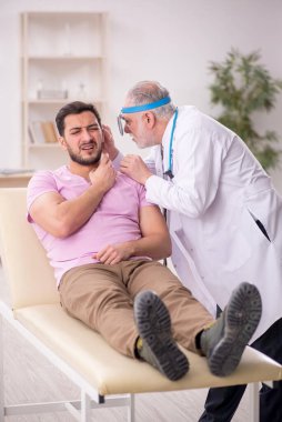 Young patient visiting old doctor otologist