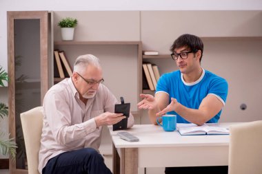 Young student and his grandfather at home