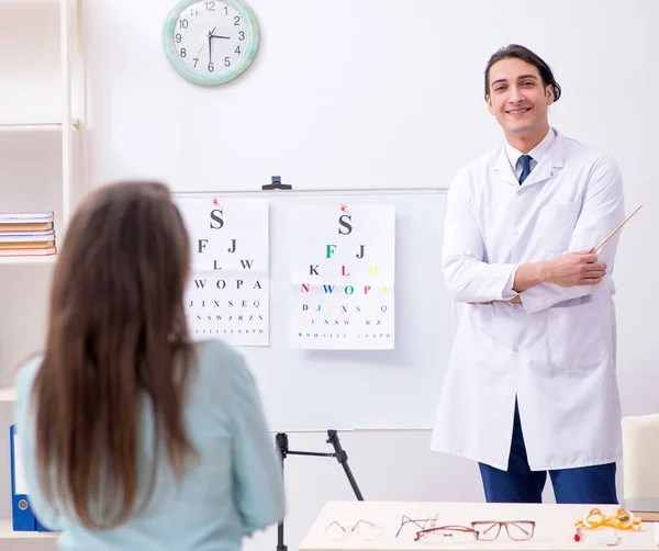 stock image The young woman visiting male doctor oculist