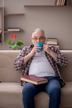 Old man sitting at home during pandemic