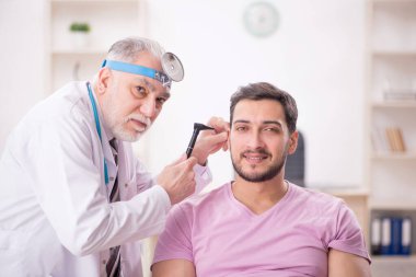 Young patient visiting old doctor otologist