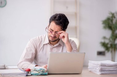 Young accountant sitting at workplace