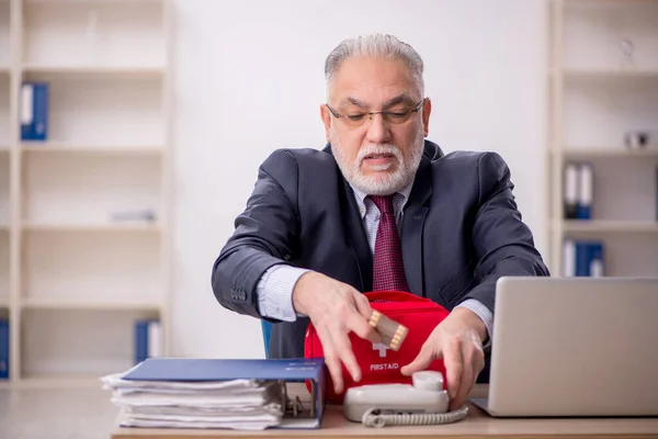 Old businessman employee feeling bad in the office