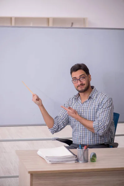 Young teacher in front of white board
