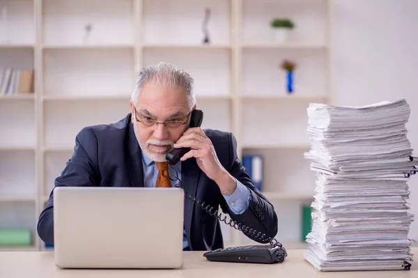 stock image Old male employee and too much work at workplace