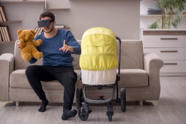 Young contractor looking after baby at home