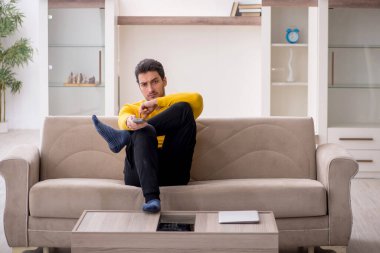 Genç erkek öğrenci salgın sırasında evde oturuyor.