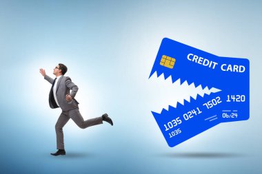 Businessman in the credit card debt concept