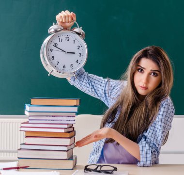 The female student in front of chalkboard