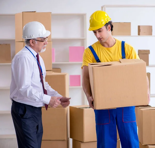 stock image The professional movers doing home relocation