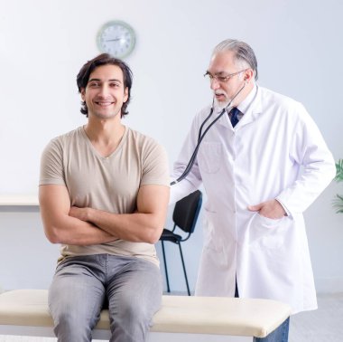 The young male patient visiting old doctor