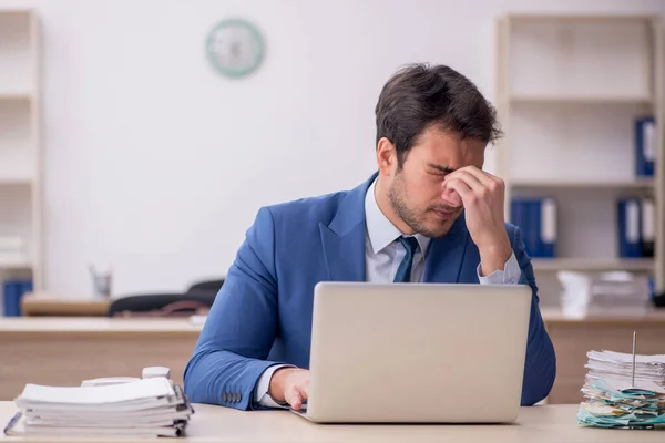 stock image Young male employee sitting at workplace