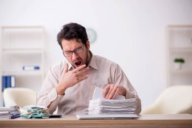 Young accountant sitting at workplace