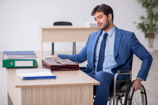 Young businessman employee in wheel-chair