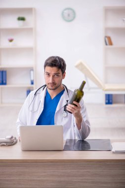 Young doctor in alcoholism concept