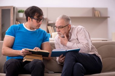 Young student and his grandfather at home