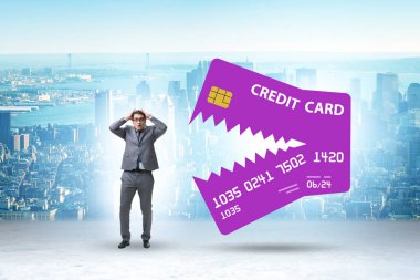Businessman in the credit card debt concept