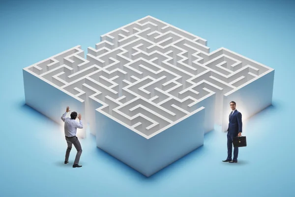 stock image Businessman trying to find a way out of the maze