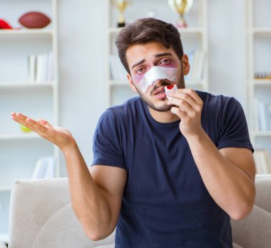 Genç adam estetik ameliyattan sonra evde iyileşiyor.