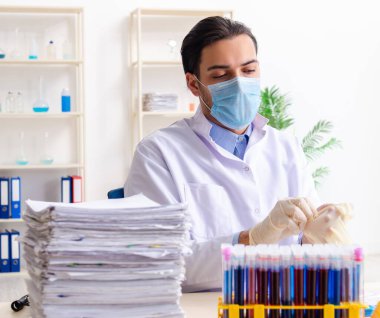 Laboratuvarda çalışan genç erkek kimyager.