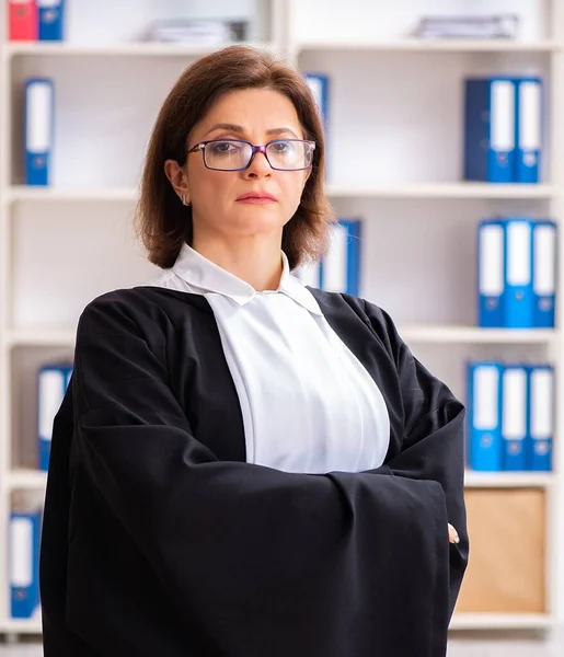 The middle-aged female doctor working in courthouse