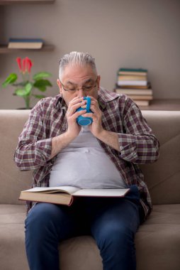 Old man sitting at home during pandemic